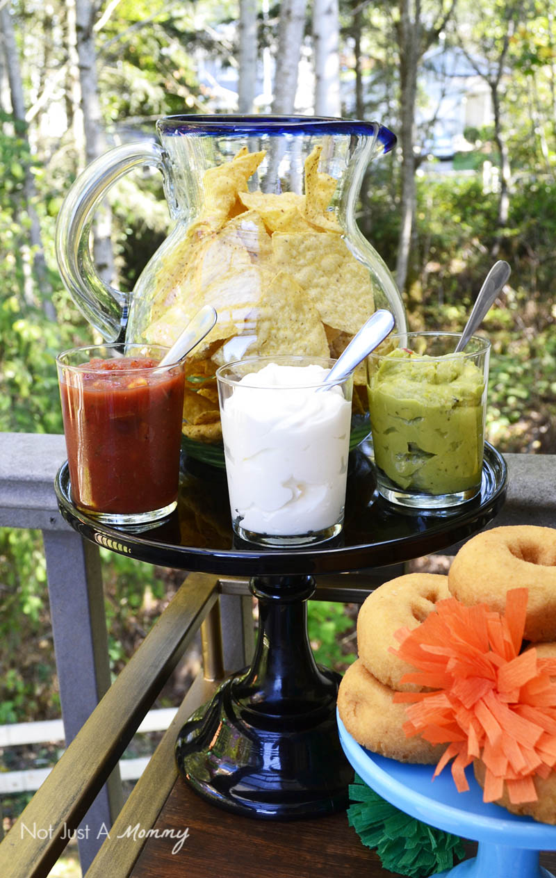 Serve chips in a colorful pitcher for a Día De Los Muertos Crafternoon Party