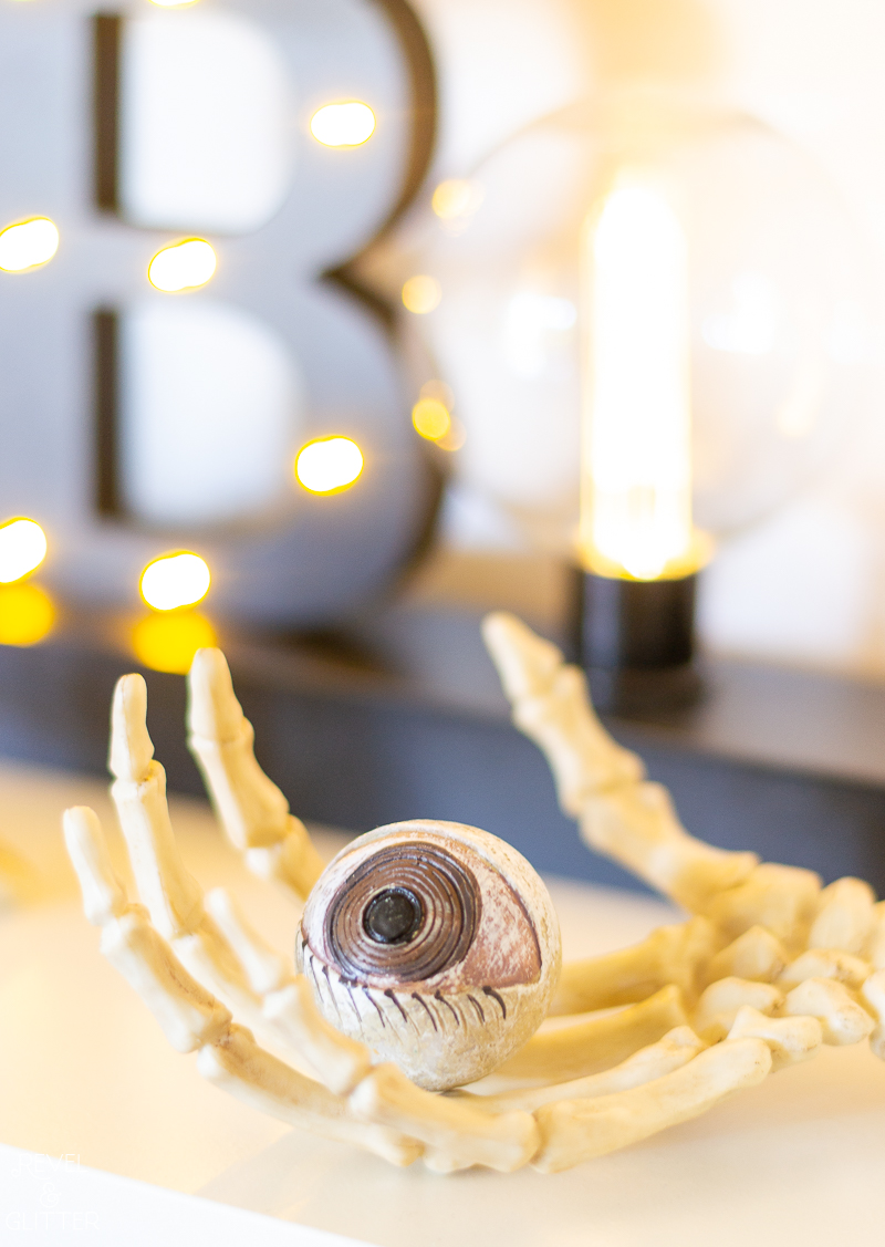 How to Style Bookshelves For Halloween; close up of skeleton hand and eyeball