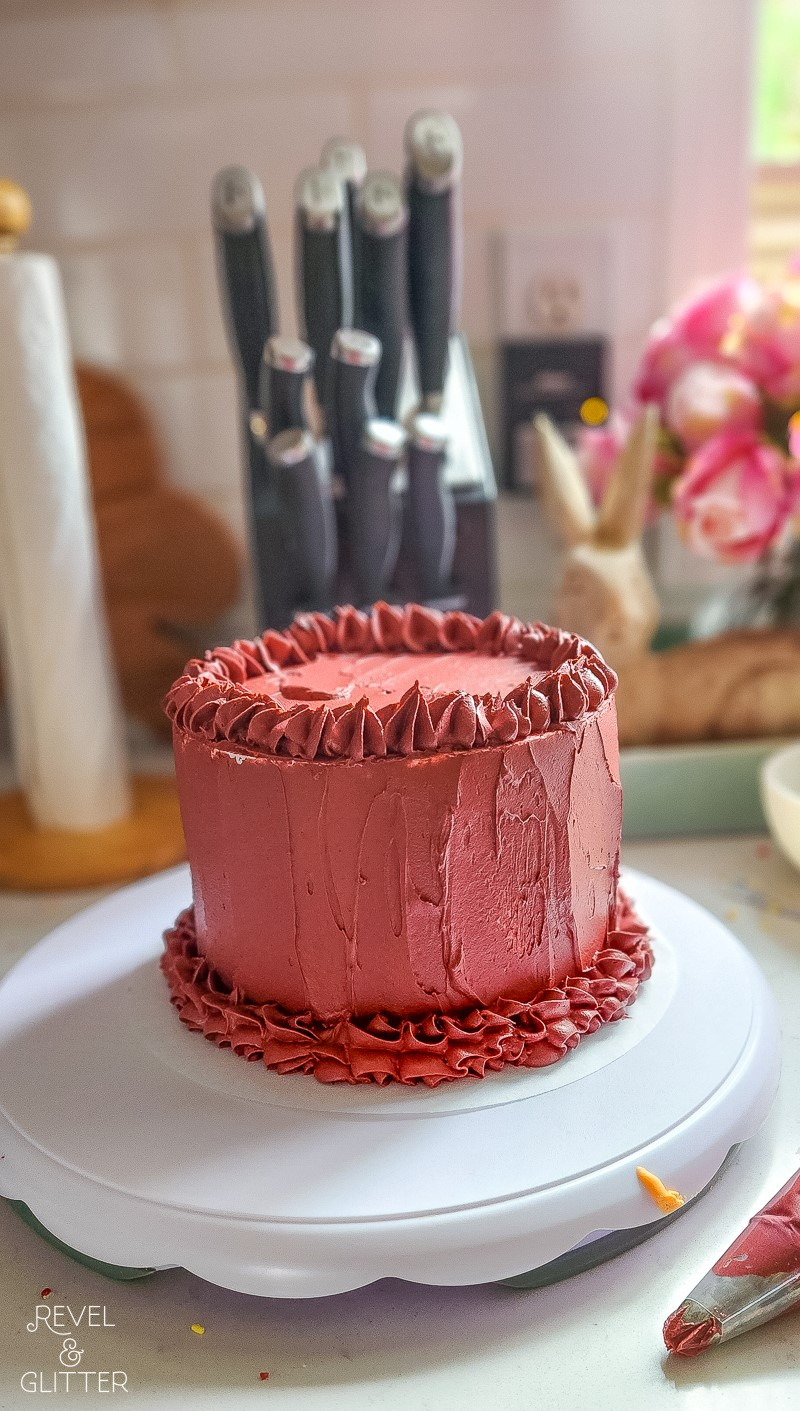 Red frosted cake on a cake turntable