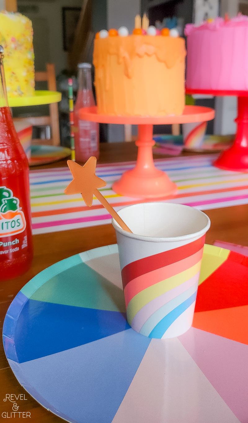 Rainbow cup sitting on a rainbow plate